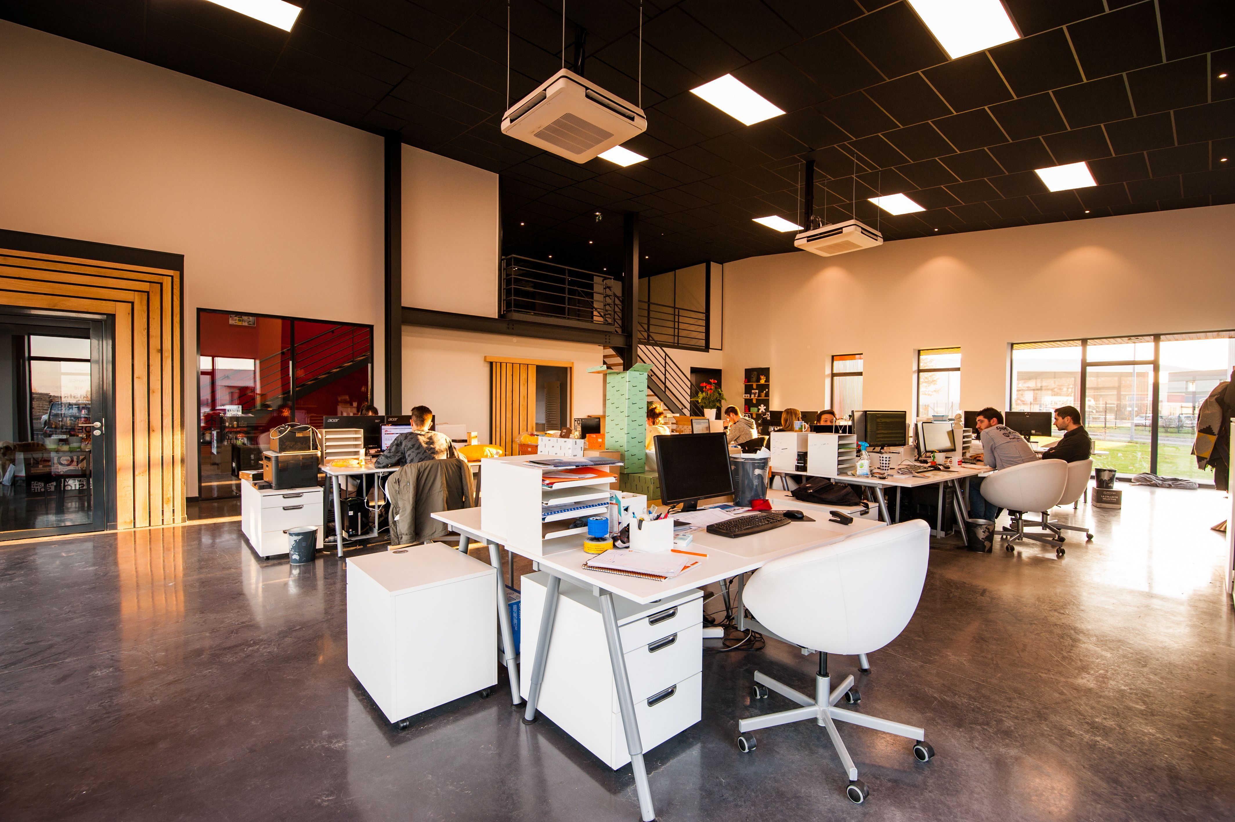 A web agency team working at desks in a modern open-plan office
