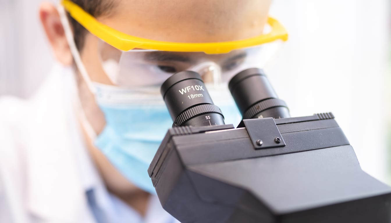 Scientist looking through a microscope in a laboratory